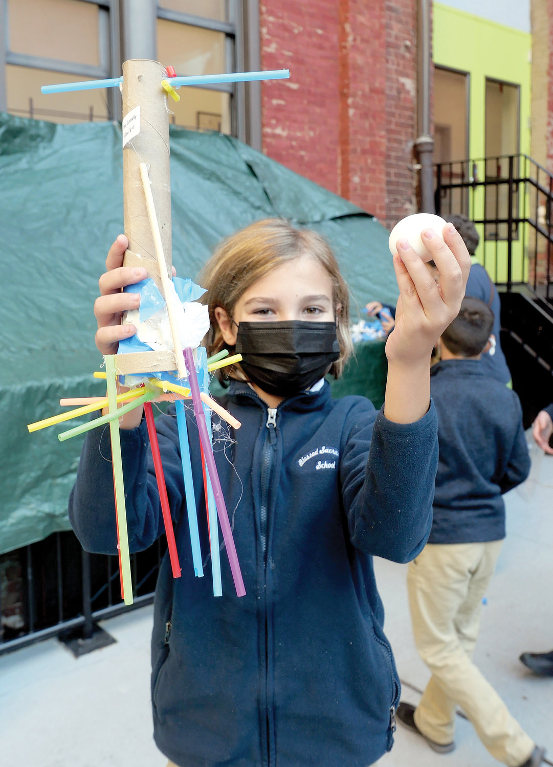 Sixth-grader Paul Connolly holds a parachute with his pristine egg.