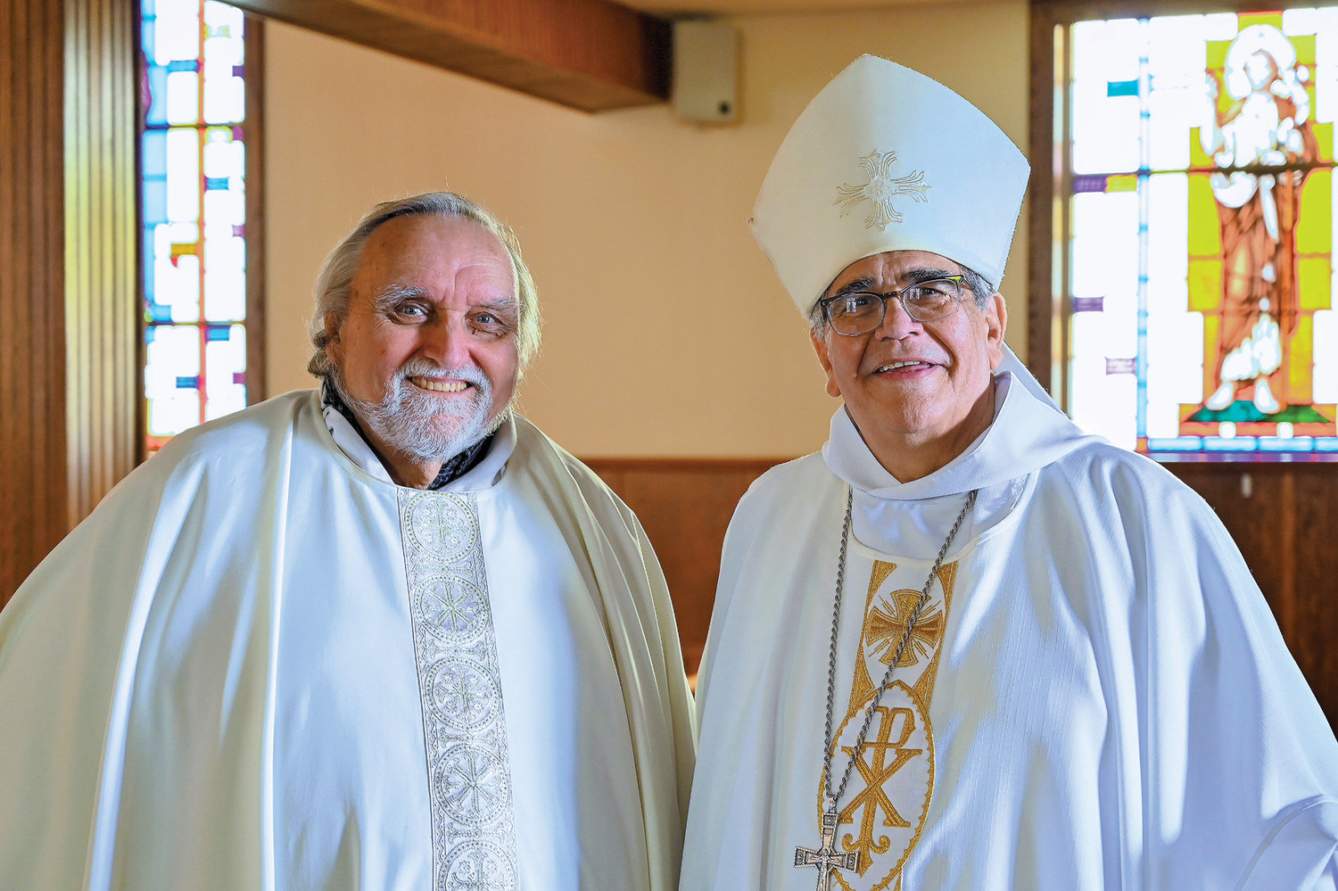 Father Bernard Heter, pastor of St. Joseph, left, and Bishop Lagonegro show their joy at the conclusion of the Mass.