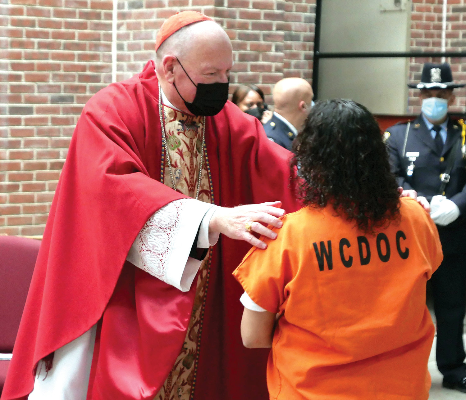 The cardinal greets a prisoner.