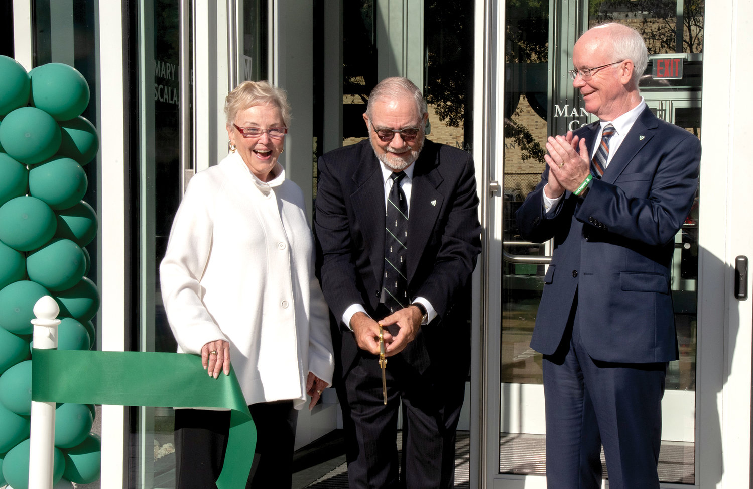 Cornelius Higgins cuts the ribbon at the formal dedication of Manhattan College’s Patricia and Cornelius J. Higgins '62 Engineering and Science Center in the Bronx Oct. 21. Joining Higgins are Patricia Higgins, Ph.D., and Brennan O’Donnell, president of Manhattan College.