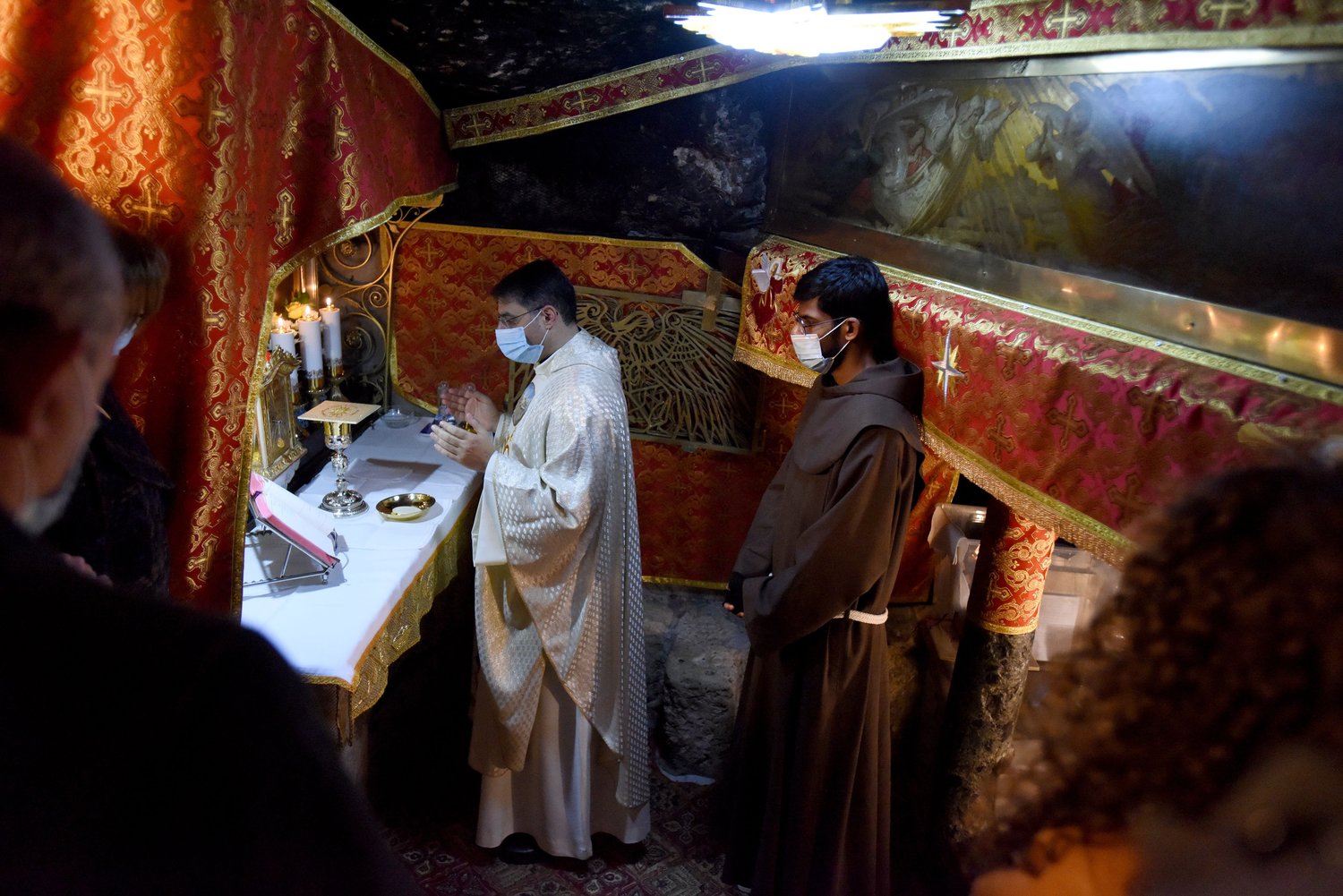 Palestinians attend Mass on Christmas morning in the grotto of the Church of the Nativity in Bethlehem, West Bank, Dec. 25.
