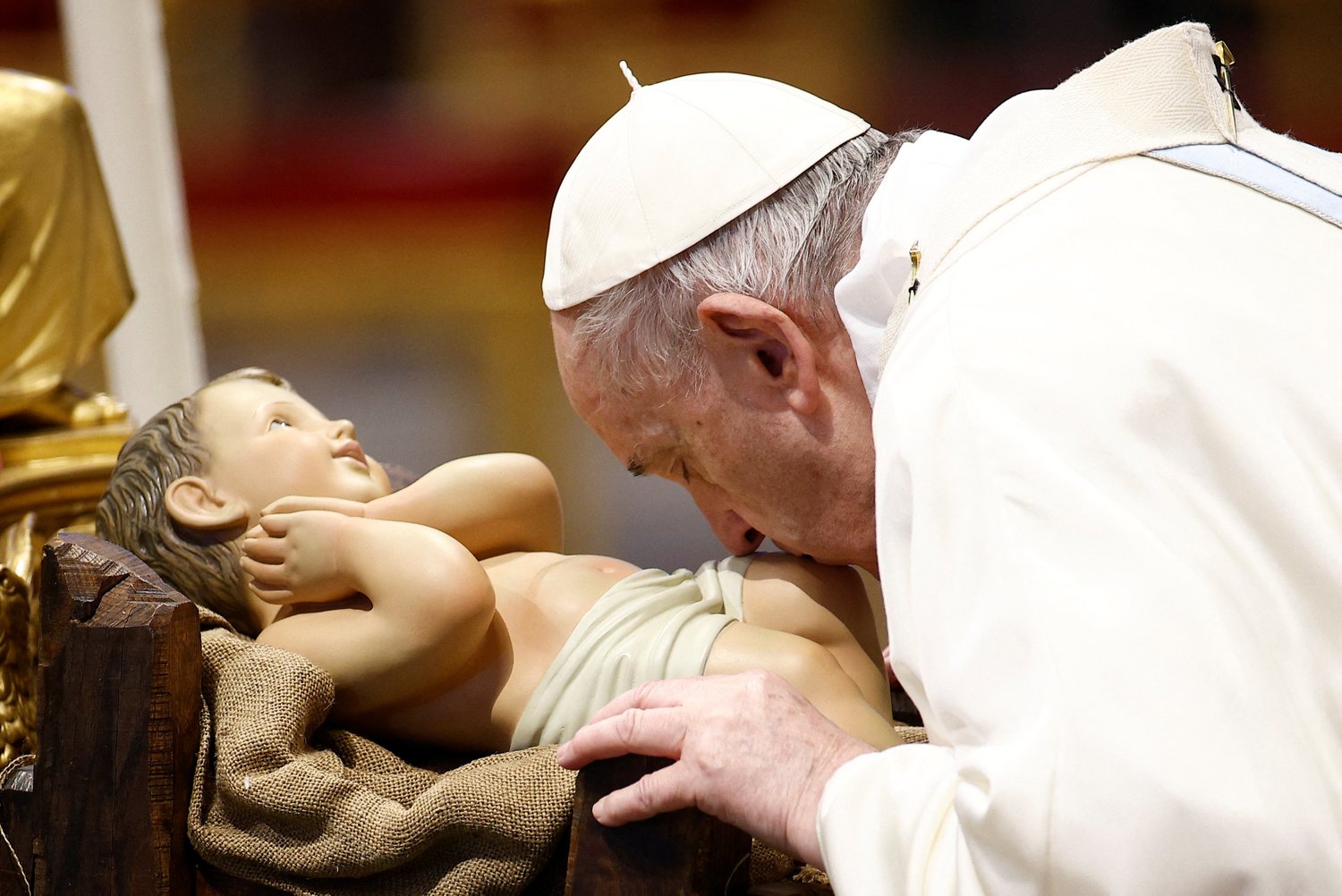 Pope Francis kisses a figurine of the Baby Jesus as he arrives to celebrate Mass marking the feast of Mary, Mother of God, in St. Peter’s Basilica at the Vatican Jan. 1.