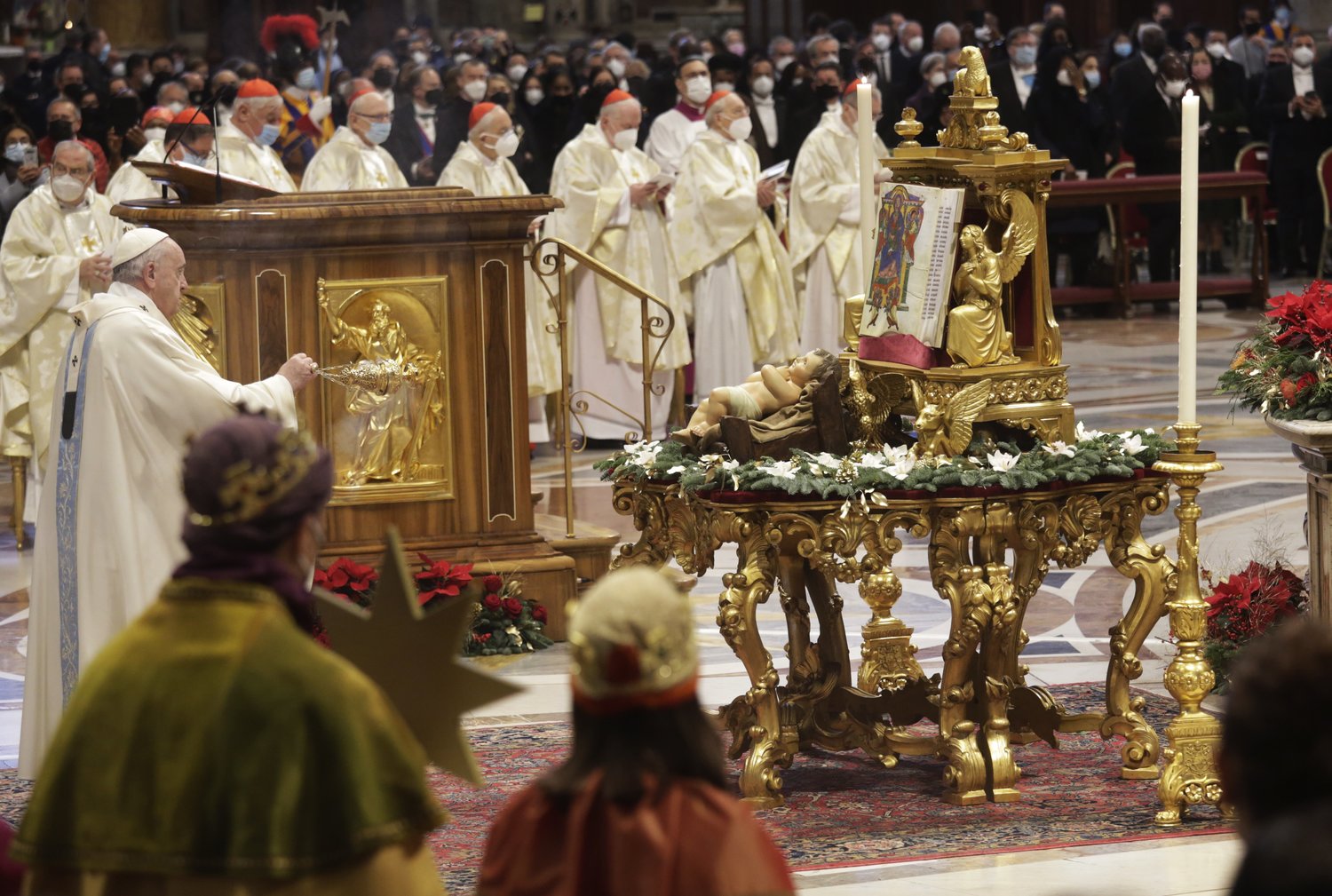 Pope Francis uses incense as he venerates a figurine of the Baby Jesus at the start of Mass marking the feast of Mary, Mother of God, in St. Peter’s Basilica at the Vatican Jan. 1. In the foreground are young people dressed as the Magi.