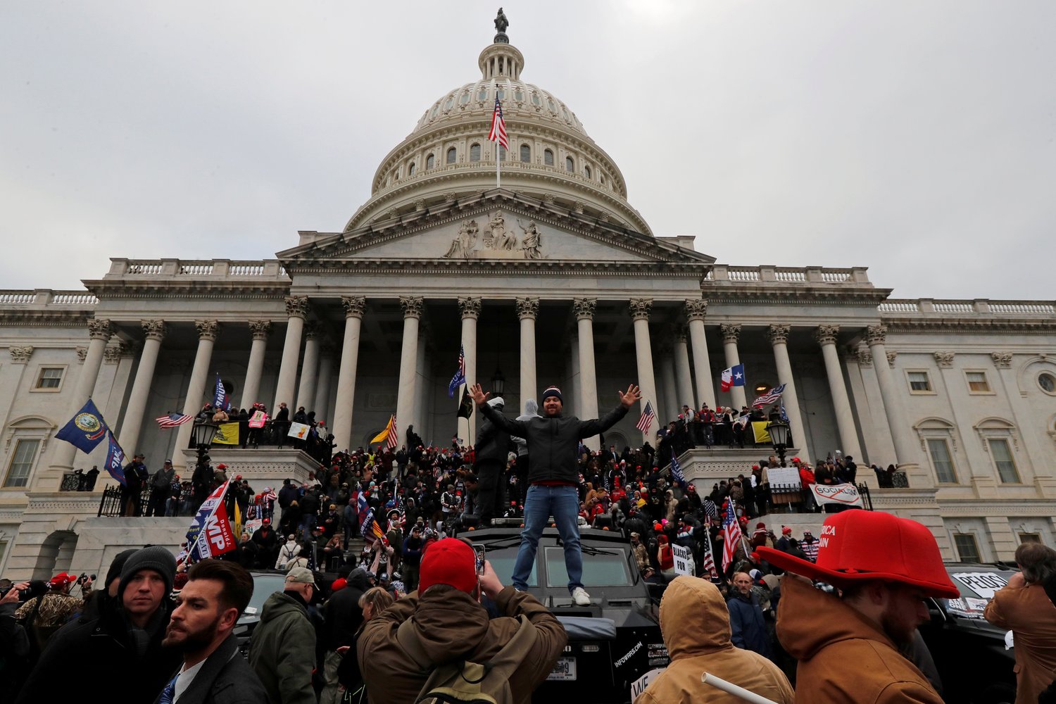 Supporters of U.S. President Donald Trump climb on walls at the U.S. Capitol during a protest against the certification of the 2020 U.S. presidential election results by the U.S. Congress, in Washington, D.C. in this Jan. 6, 2021, file photo. A year after the assault on the Capitol, the Vatican newspaper says it was “a direct blow to the heart of American democracy.”