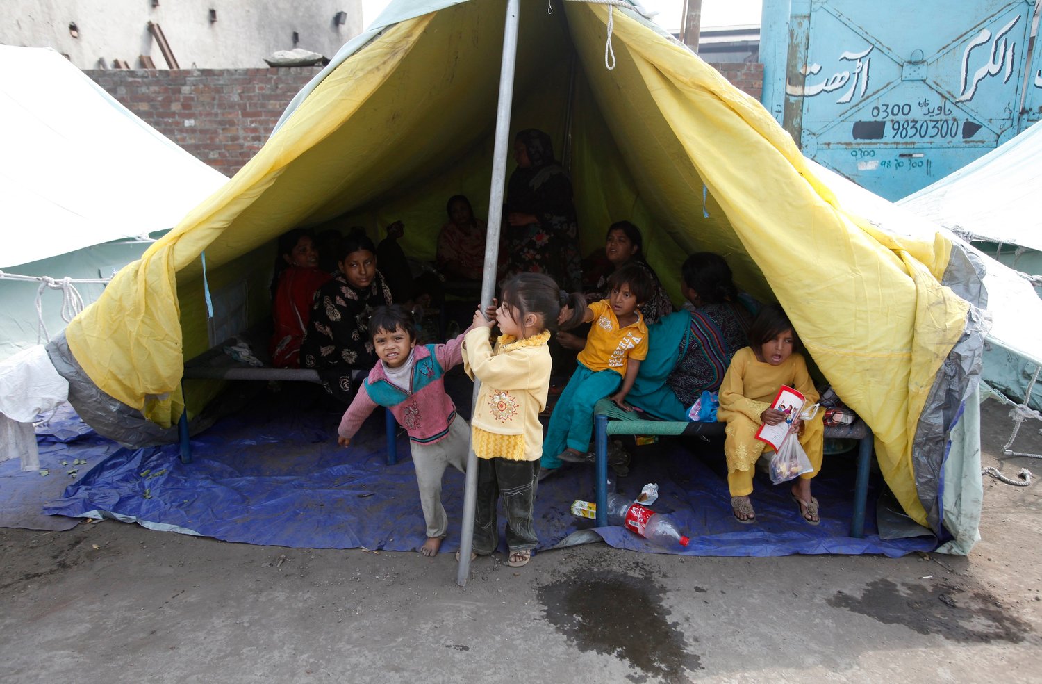 Pakistani Christian children play in front of tents provided for Christian families whose homes were set on fire by a mob, in Lahore, Pakistan, in this March 12, 2013, file photo. In a video message released by the Pope’s Worldwide Prayer Network Jan. 3, the pope dedicated his prayer intention for people who suffer from religious discrimination and persecution.