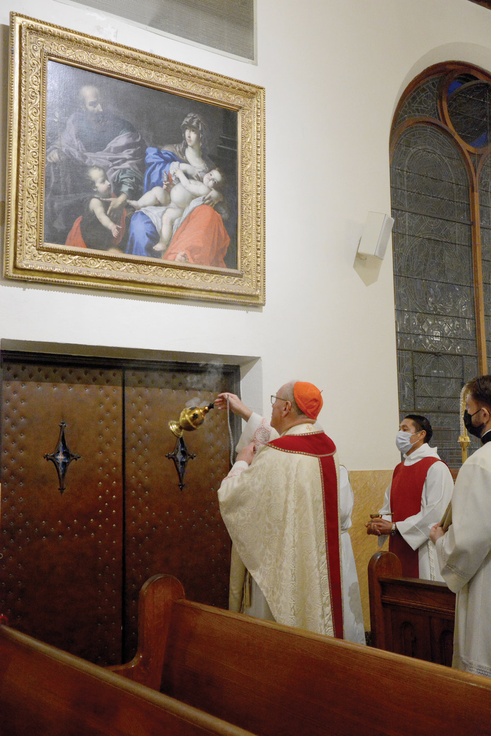 Cardinal Dolan blesses with incense the 17th-century masterpiece “Holy Family with the Infant St. John,” a Florentine Baroque by Cesare Dandini, Jan. 1 at Holy Family Church in New Rochelle where he celebrated the 5 p.m. Vigil Mass of the Epiphany of the Lord.