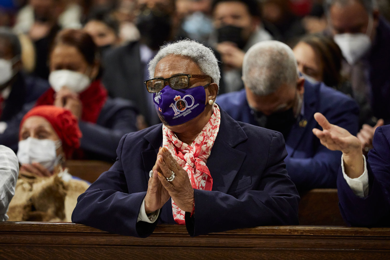A woman prays at the annual Mass honoring Our Lady of Altagracia at St. Patrick’s Cathedral Jan. 16. Her mask refers to the centennial of the canonical coronation of Our Lady of Altagracia, which is being observed in the Dominican Republic and New York.