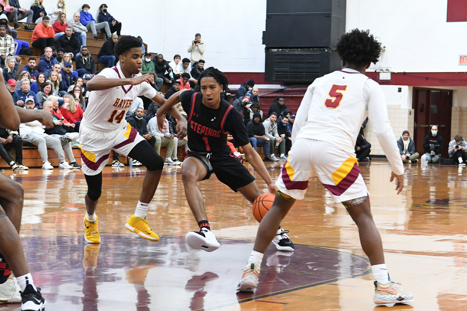 Archbishop Stepinac High School’s Danny Carbuccia dribbles the basketball as Cardinal Hayes’ Tyliek Fields defends during the Archdiocesan boys’ basketball championship game won by Stepinac, 51-40, at Christ the King High School in Queens Feb. 26.