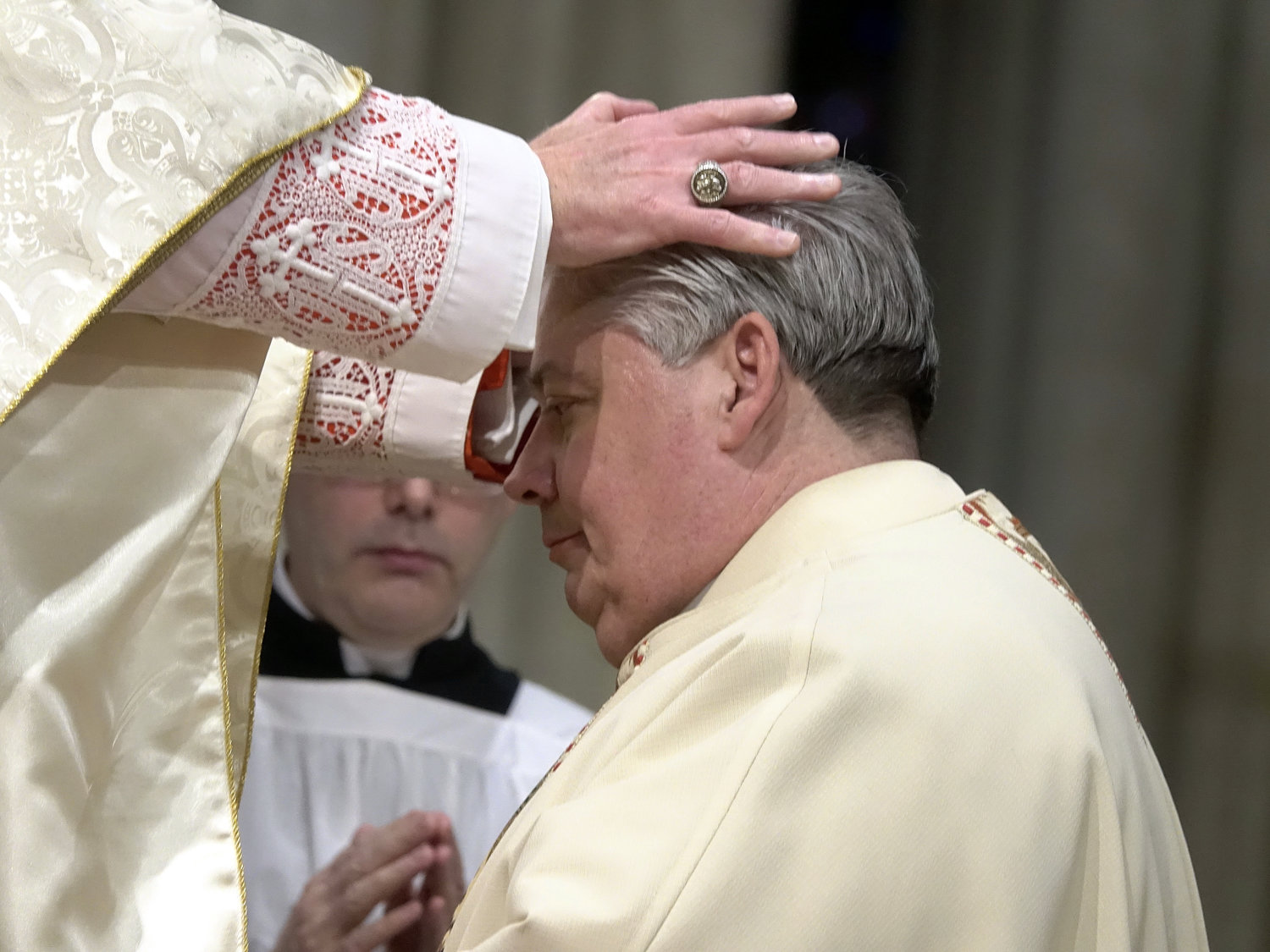 Cardinal Dolan lays hands on the head of Auxiliary Bishop John S. Bonnici, 57, during his episcopal ordination March 1 at St. Patrick's Cathedral.