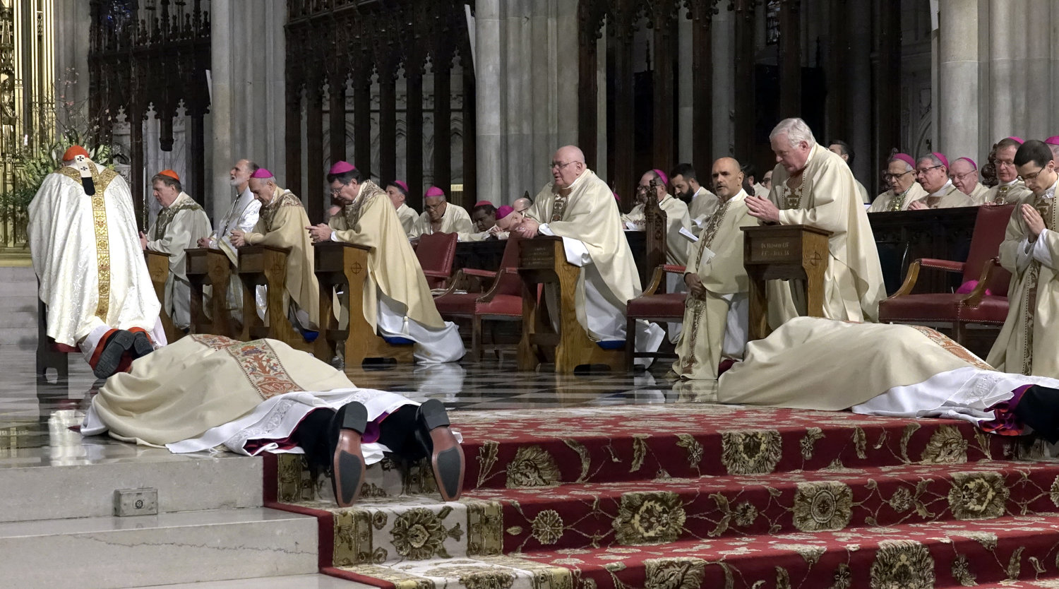 The bishops-elect lay prostrate in the cathedral sanctuary during the ordination rite.