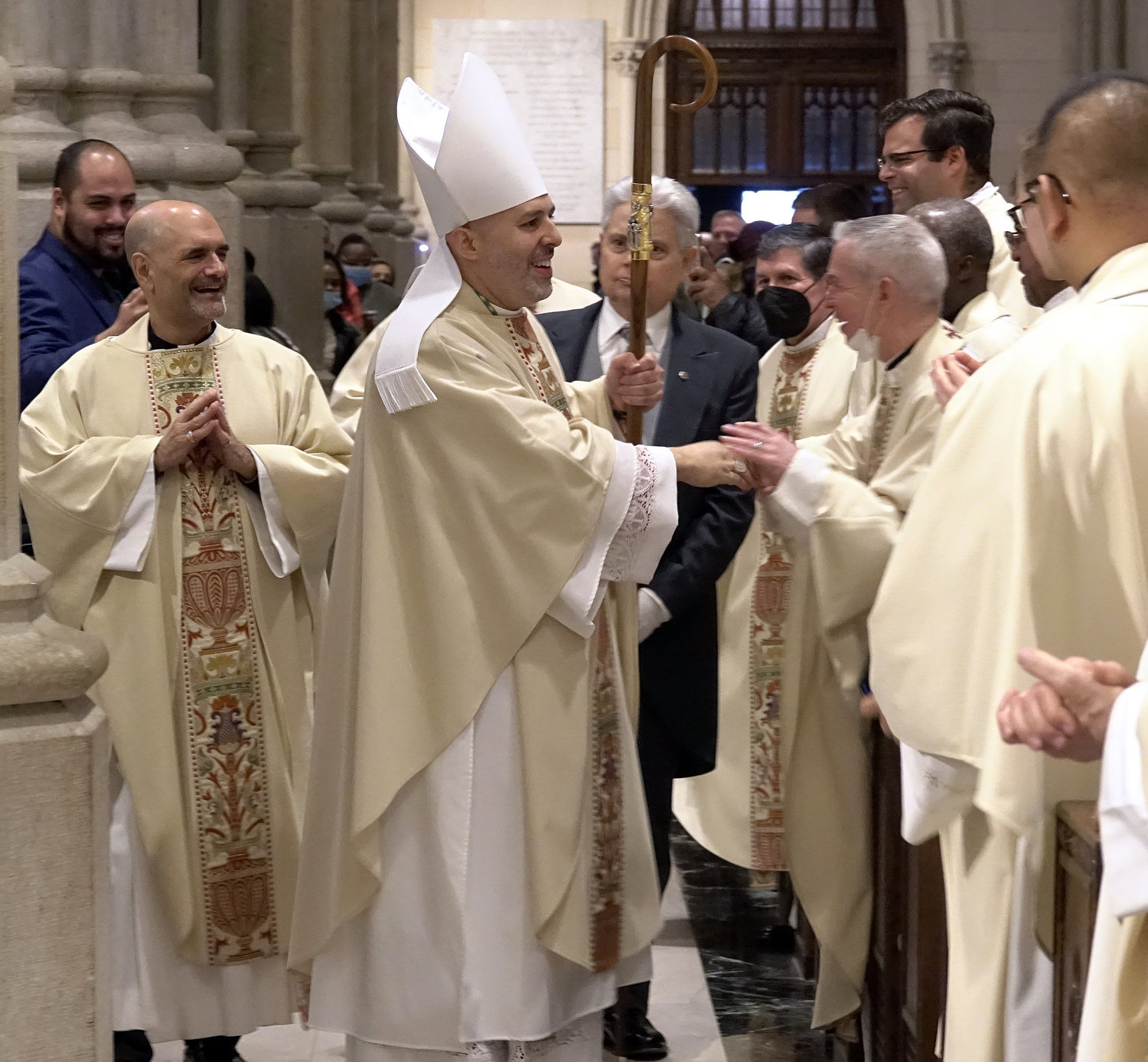 Auxiliary Bishop Joseph A. Espaillat greets clergy after his ordination. With him at left is Father Arthur Mastrolia, pastor of St. Clare’s parish on Staten Island.