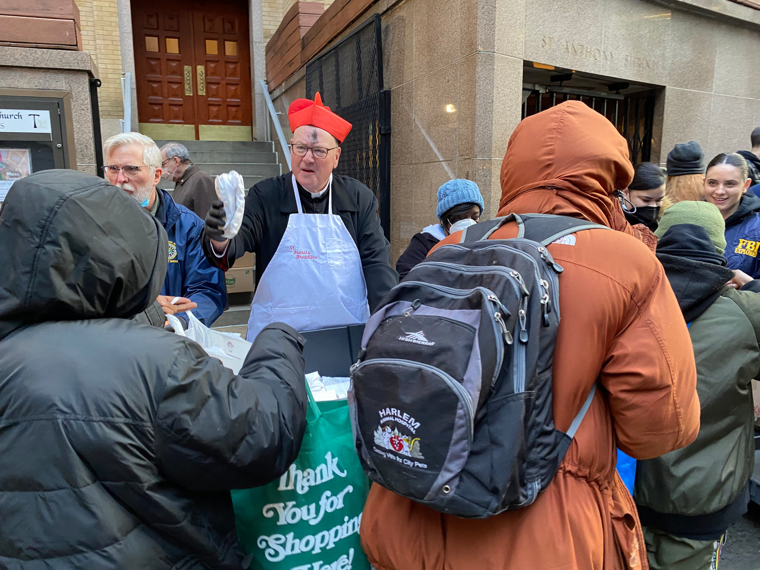 DAILY BREAD—Cardinal Dolan distributes sandwiches to those in need on the St. Francis Breadline on Ash Wednesday, March 1. The breadline, outside St. Francis of Assisi Church on West 31st Street in Manhattan, has helped hundreds of people each day for more than nine decades.