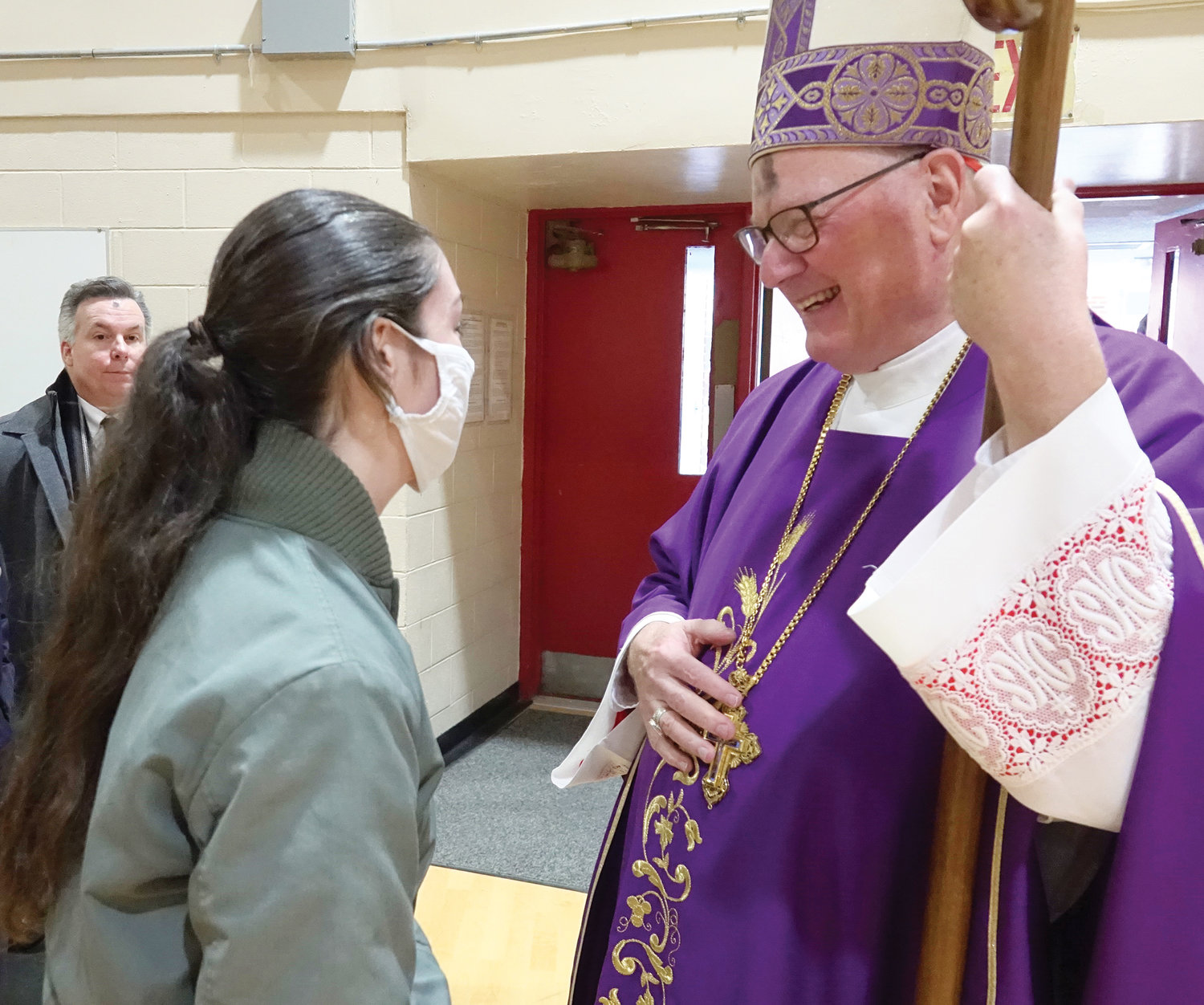 An inmate speaks with Cardinal Dolan.
