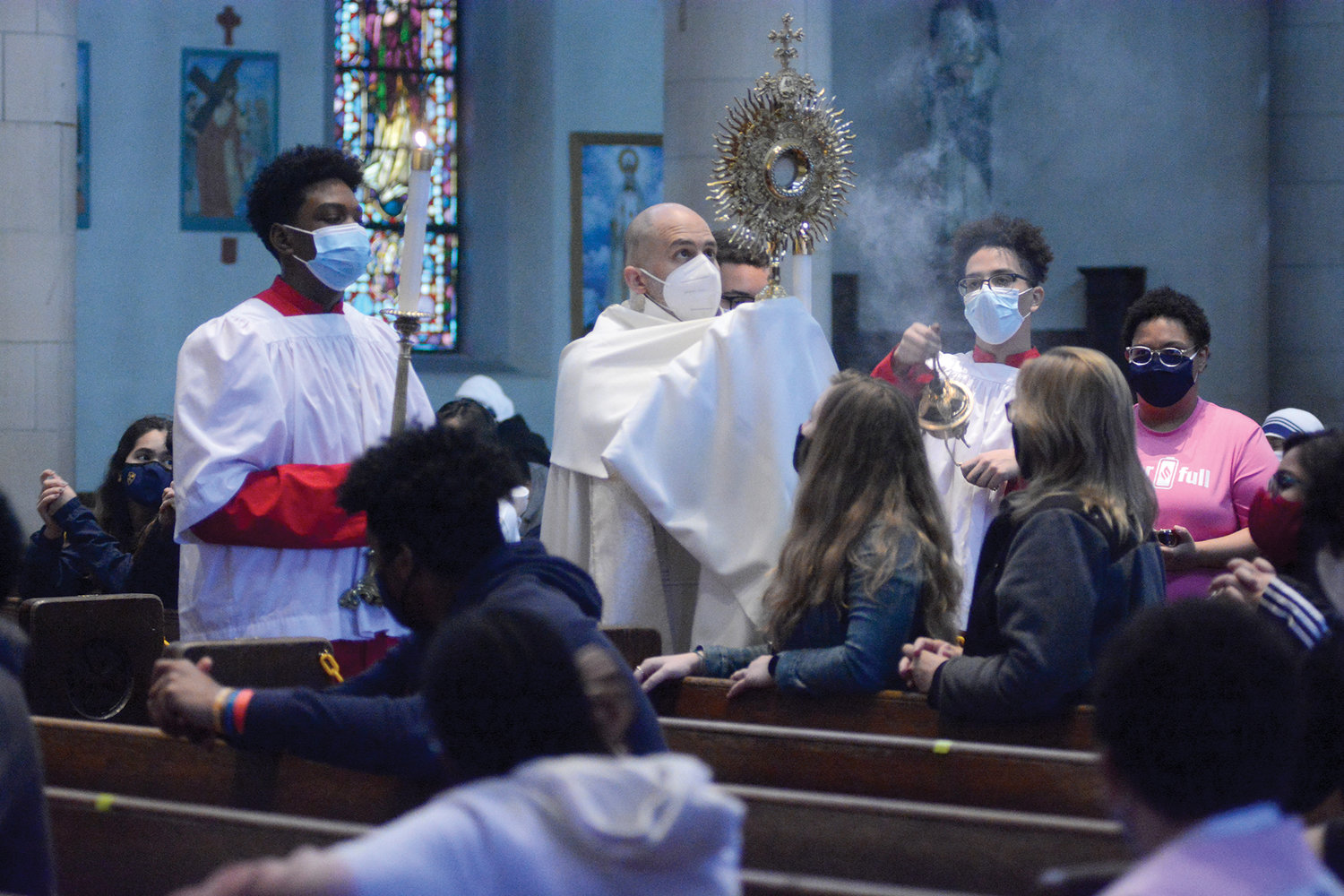 HOLY HOUR—Then-Father Joseph A. Espaillat reverently holds a monstrance during Holy Hour last May at the 2021 New York Catholic Youth Day at St. Anthony of Padua Church in the Bronx, where he is pastor. He spoke to the youths about the importance of seeing the Light of Christ.