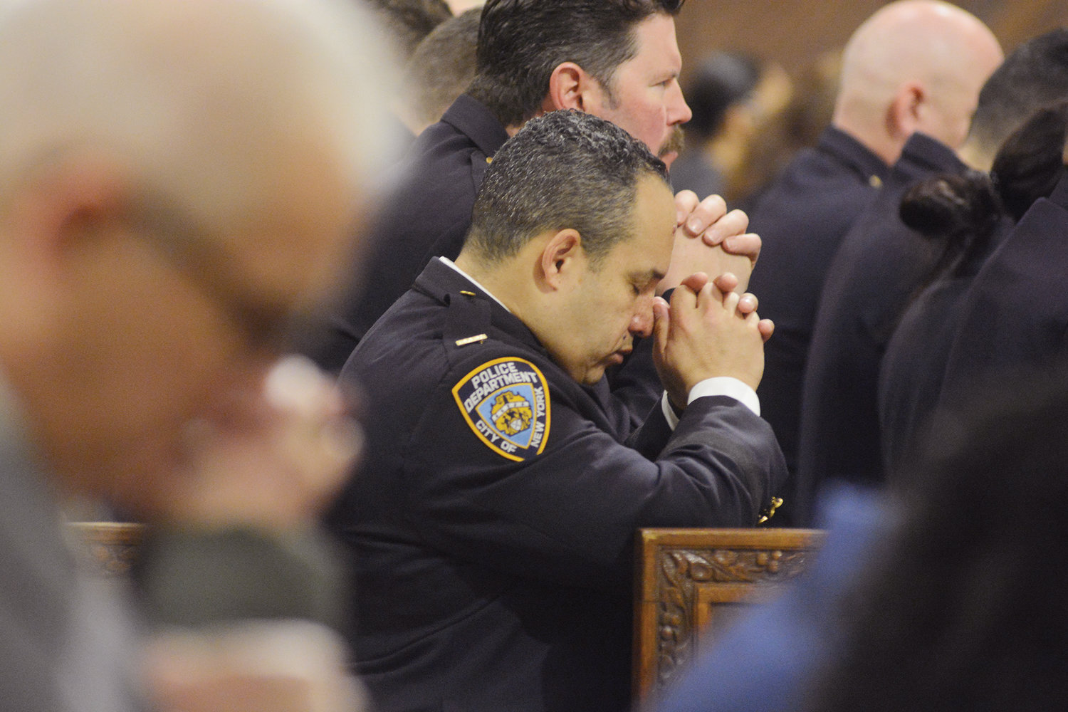 Officers pray in the pews.