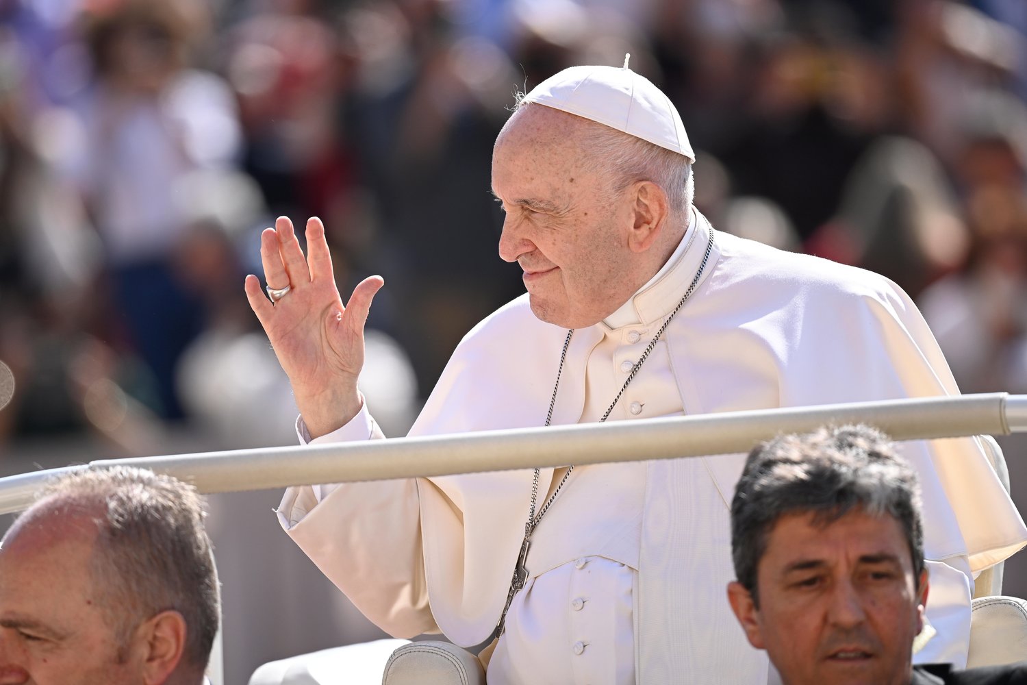 Pope Francis waves to the crowd gathered in St. Peter’s Square at the Vatican May 11 for his weekly general audience.
