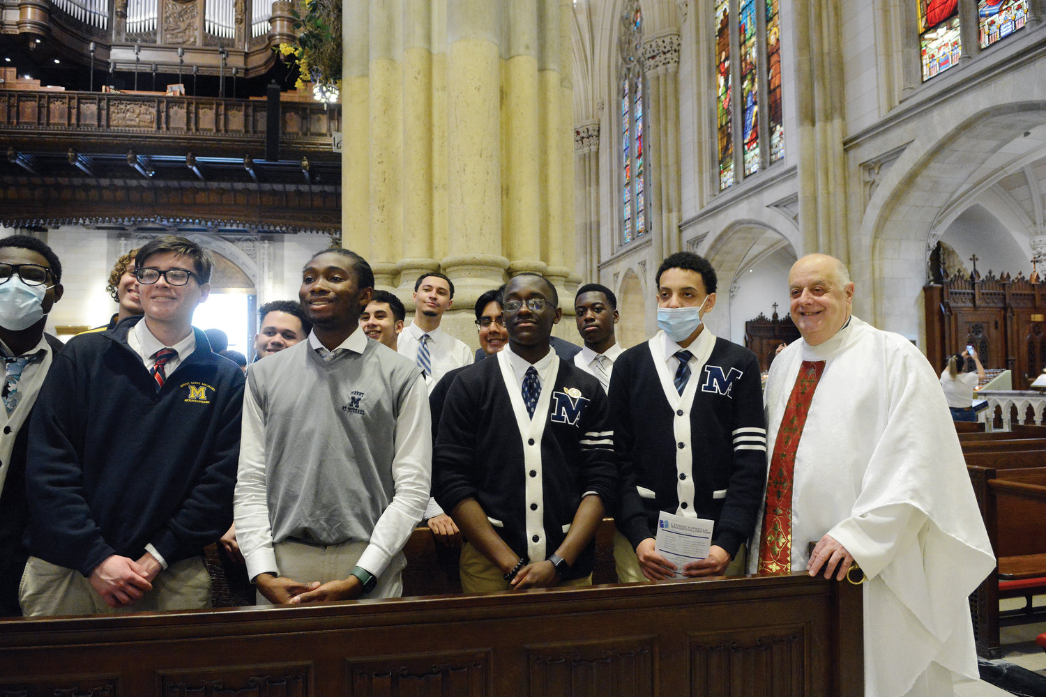 Msgr. Joseph LaMorte, vicar general for the archdiocese and a graduate of Mount St. Michael Academy in the Bronx, poses with students from that school at a May 16 Mass Cardinal Dolan celebrated at St. Patrick’s Cathedral for graduating seniors at Catholic high schools in the archdiocese.