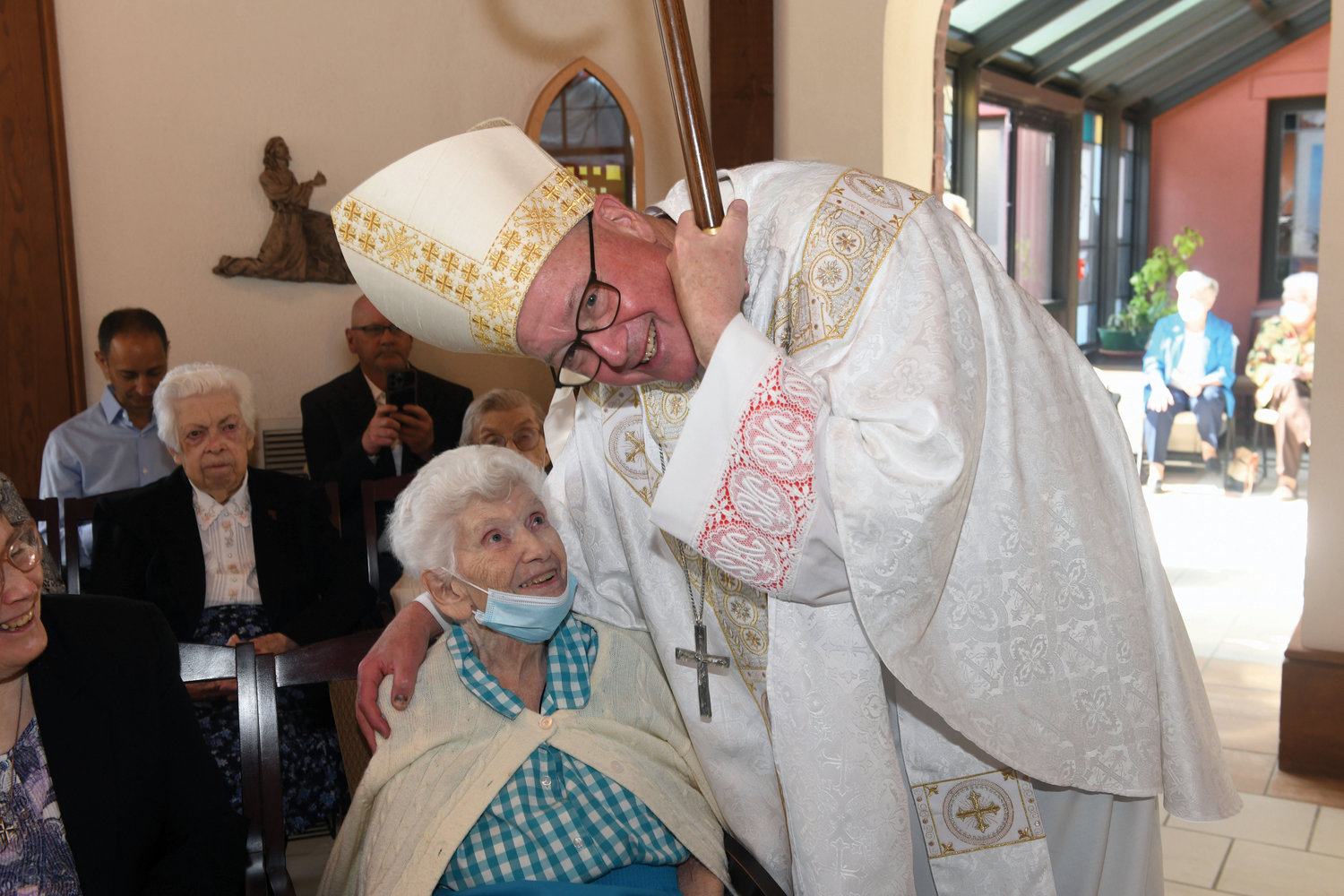 Cardinal Dolan greets Sister Mary Elizabeth Dolan, R.S.M., an original resident.