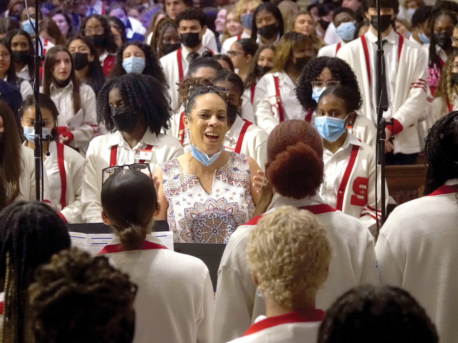 Mila Bello directs the Gospel choir of Cardinal Spellman High School, the Bronx.