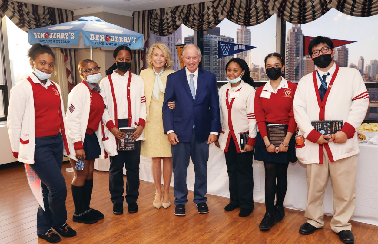 Christine and Stephen Schwarzman, center, host a graduation celebration May 17 for the 90 Catholic high school seniors they sponsor with tuition assistance through the Inner-City Scholarship Fund in Dillon Hall at the New York Catholic Center in Manhattan.