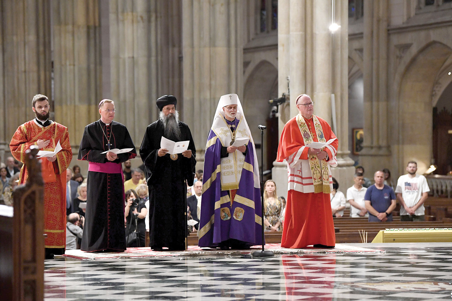 Cardinal Dolan and Archbishop Borys Gudziak of the Ukrainian Catholic Archeparchy of Philadelphia, to the left of the cardinal, lead a prayer service for  victims of the war in Ukraine June 11 at St. Patrick’s Cathedral. Also attending the Panakhyda (service for the deceased) were His Grace Bishop David of the Coptic Orthodox Diocese of New York and New England, center, and Auxiliary Bishop Edmund Whalen, second from left.