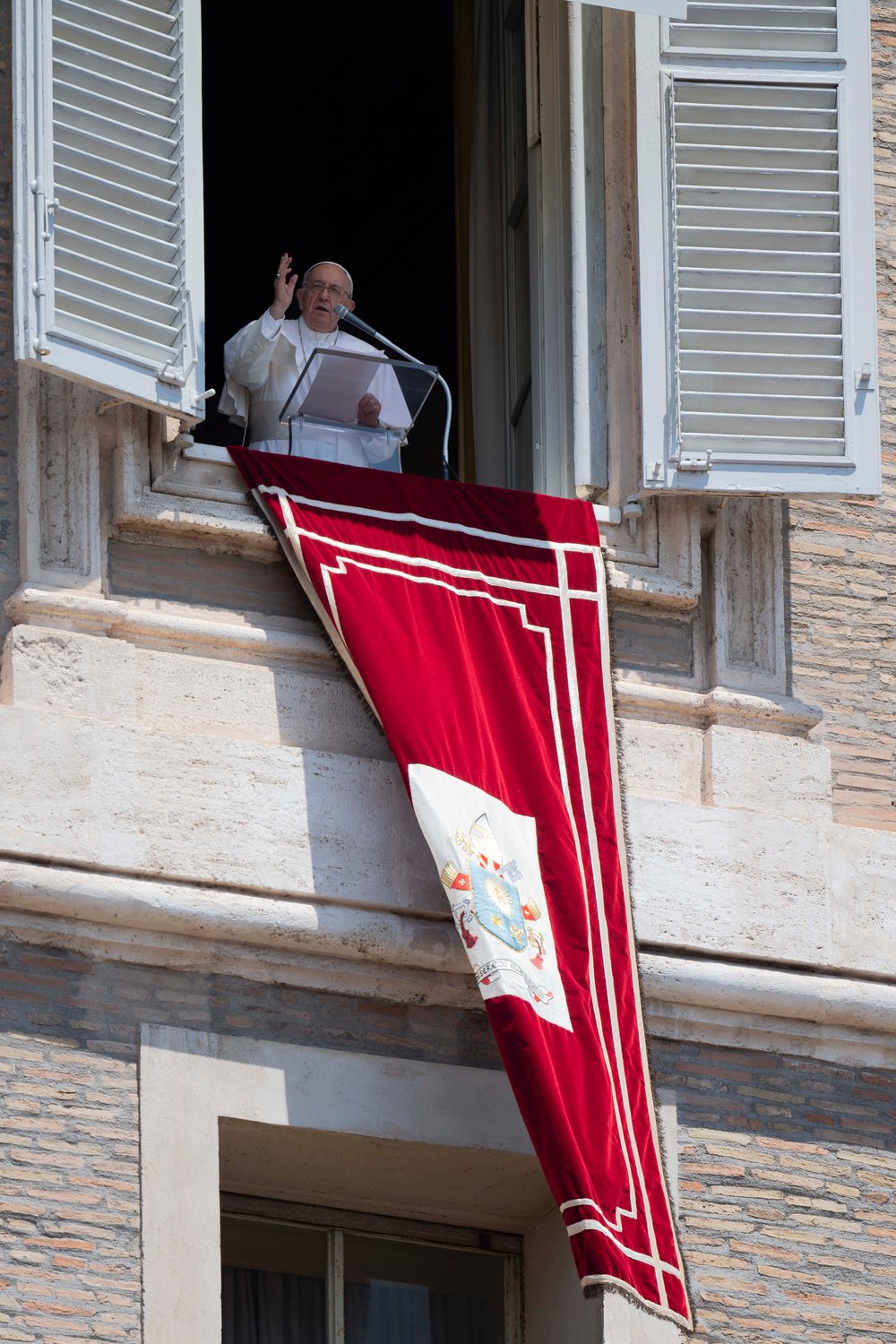 Pope Francis delivers his blessing as he leads the Angelus from the window of his studio overlooking St. Peter’s Square at the Vatican June 19.