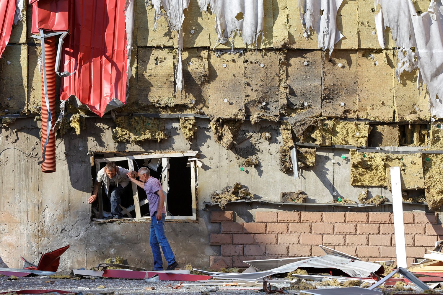 A man gets out of a damaged residential building following recent shelling in the course of the Ukrainian-Russian conflict in Donetsk, Ukraine, June 20.