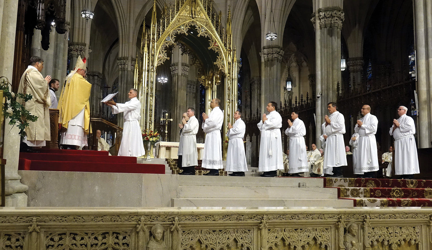 The 10 men to be ordained to the permanent diaconate gather before Cardinal Dolan June 18 during the Rite of Ordination at St. Patrick’s Cathedral.