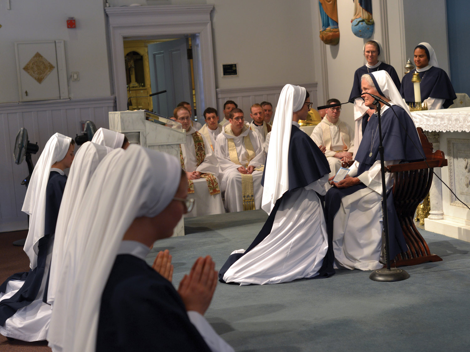Mother Agnes Mary Donovan, S.V., superior general, seated, receives vows.
