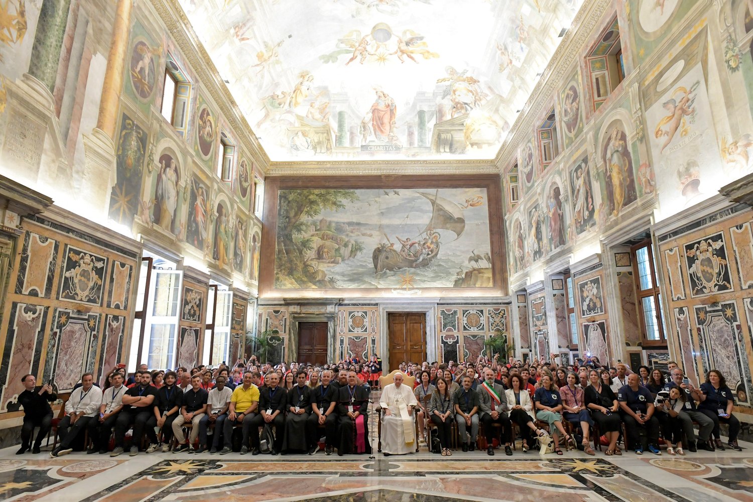 Pope Francis is pictured with young people participating in a summer camp program sponsored by Alpha International during an audience at the Vatican Aug. 5.