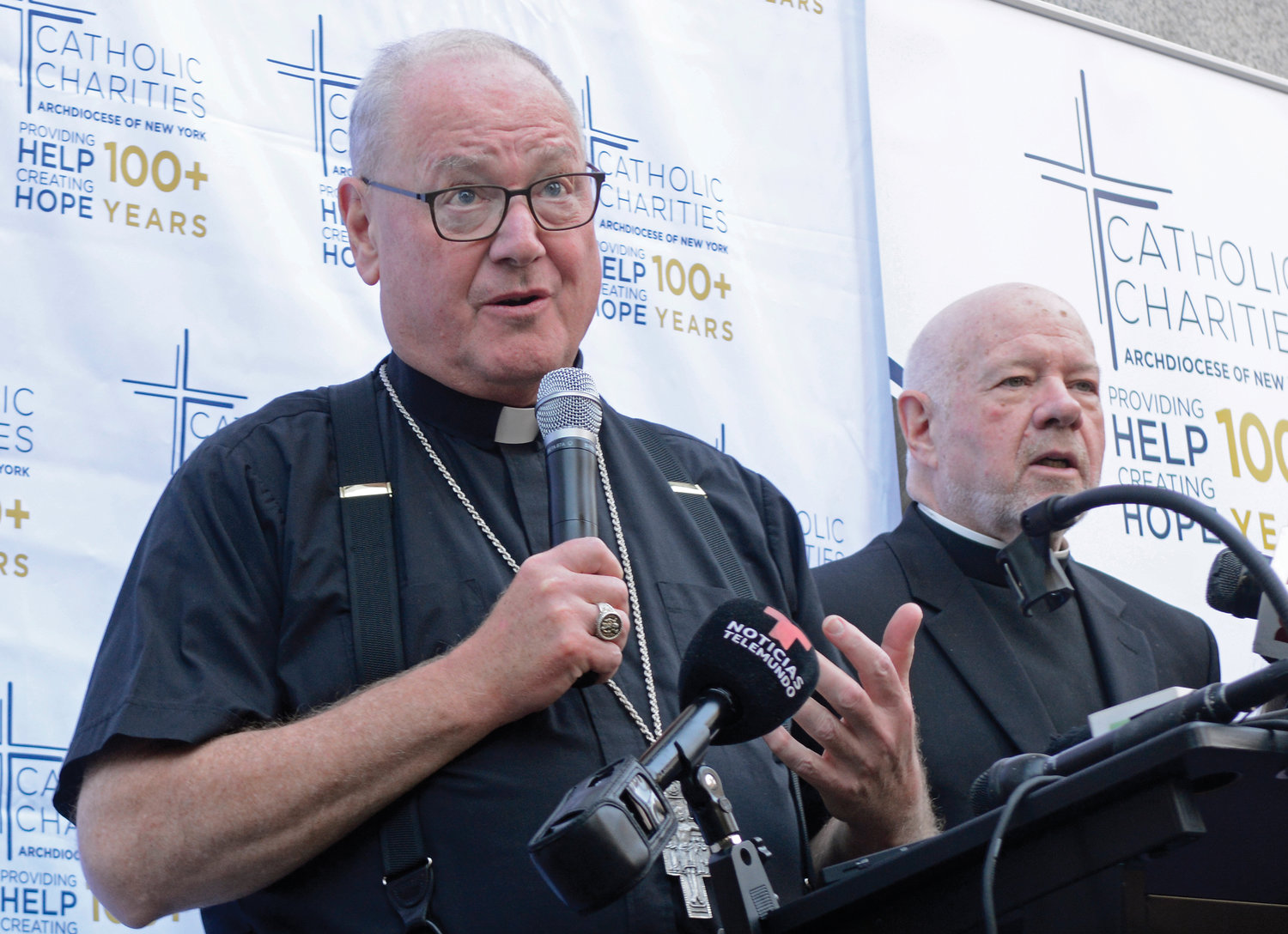 The cardinal, Msgr. Kevin Sullivan and others held a media briefing outside the center.