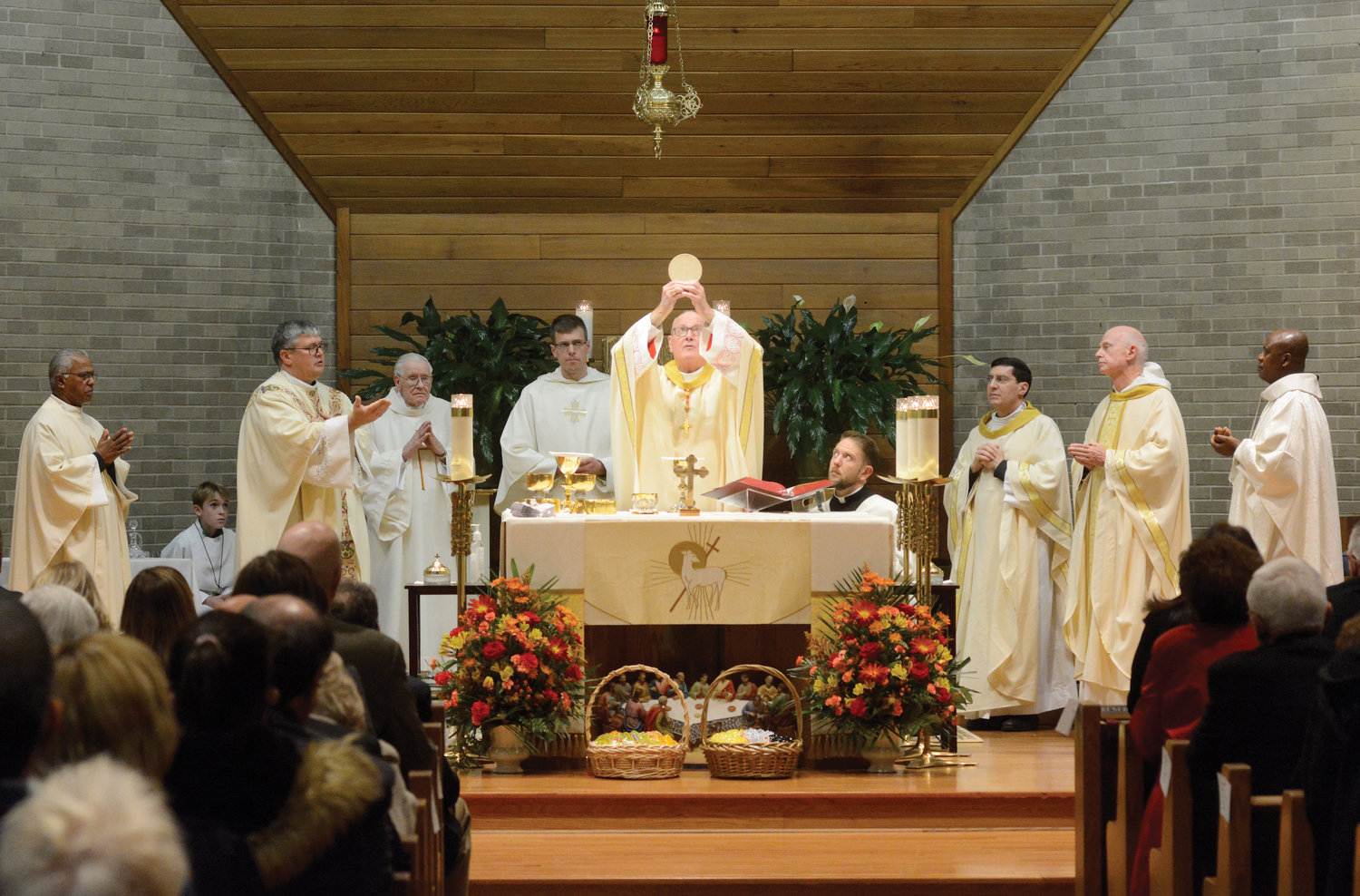 LORD’S TABLE—Cardinal Dolan elevates the Eucharist during the consecration at a Mass last Nov. 20 celebrating the 125th anniversary of Holy Name of Jesus parish in Valhalla.