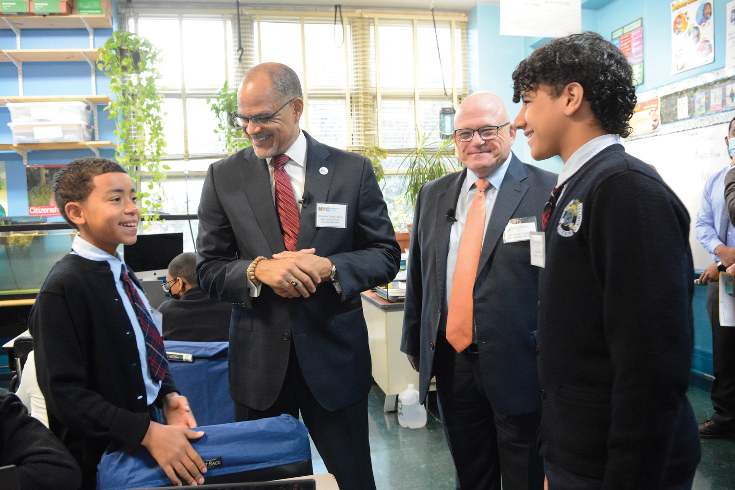 New York City Schools Chancellor David Banks and archdiocesan Superintendent of Schools Michael Deegan, second and third from left, cheerfully converse with Mathias Dominguez, far left, and Bryan Ramirez, eighth-graders and student tour guides at Our Lady Queen of Martyrs School in the Inwood section of Manhattan Oct. 4. The administrators toured Queen of Martyrs at 71 Arden St. and two nearby public schools, Muscota New School and Amistad Dual Language School, at 4862 Broadway.