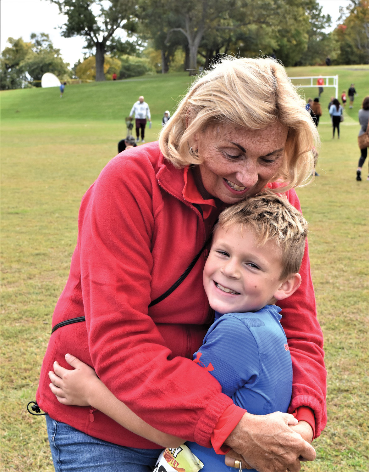 Declan O’Keefe, 9, receives a hug from his grandmother, Mary O’Keefe, after winning the CYO cross-country race for boys in grades three through five at St. Joseph’s Seminary, Dunwoodie, Oct. 8.