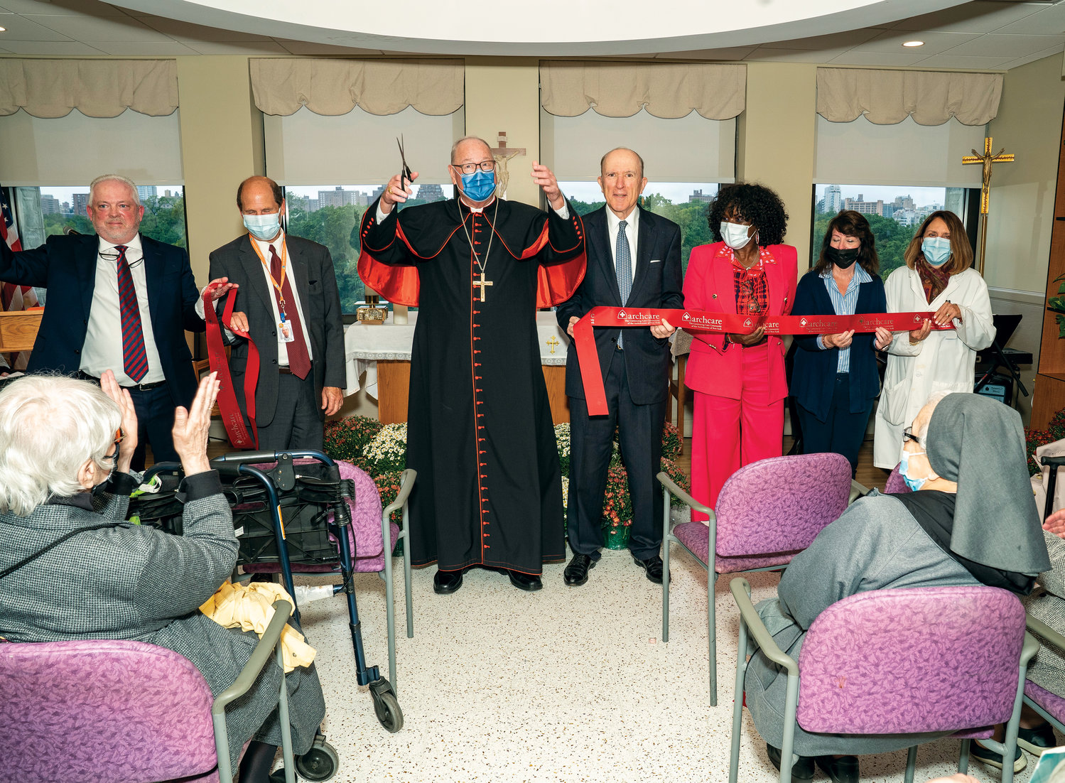 Cardinal Dolan cuts the ribbon at the grand opening of ArchCare at Mother Cabrini Hospital, formerly known as the Specialty Hospital for Children, Oct. 4 in Manhattan. With the cardinal, from left, are Scott LaRue, president and CEO of ArchCare; Mitchell Marsh, senior vice president, Residential Services of ArchCare facilities; Francis J. Serbaroli, chairman, ArchCare board of trustees; Rosalie Bernard, executive director, ArchCare at Terence Cardinal Cooke Health Care Center; Annmarie Covone, executive vice president/CFO of ArchCare; Dr. Vicki-Jo Deutsch, medical director, ArchCare at Mother Cabrini Hospital.