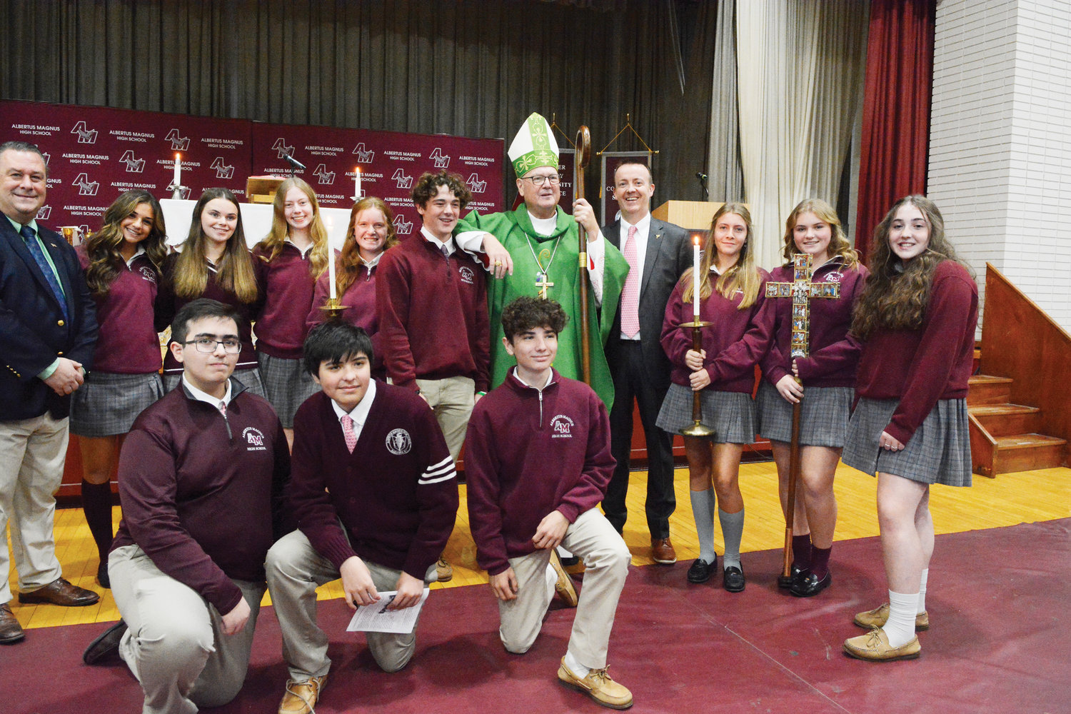 The cardinal greets students and staff who assisted at the morning liturgy.
