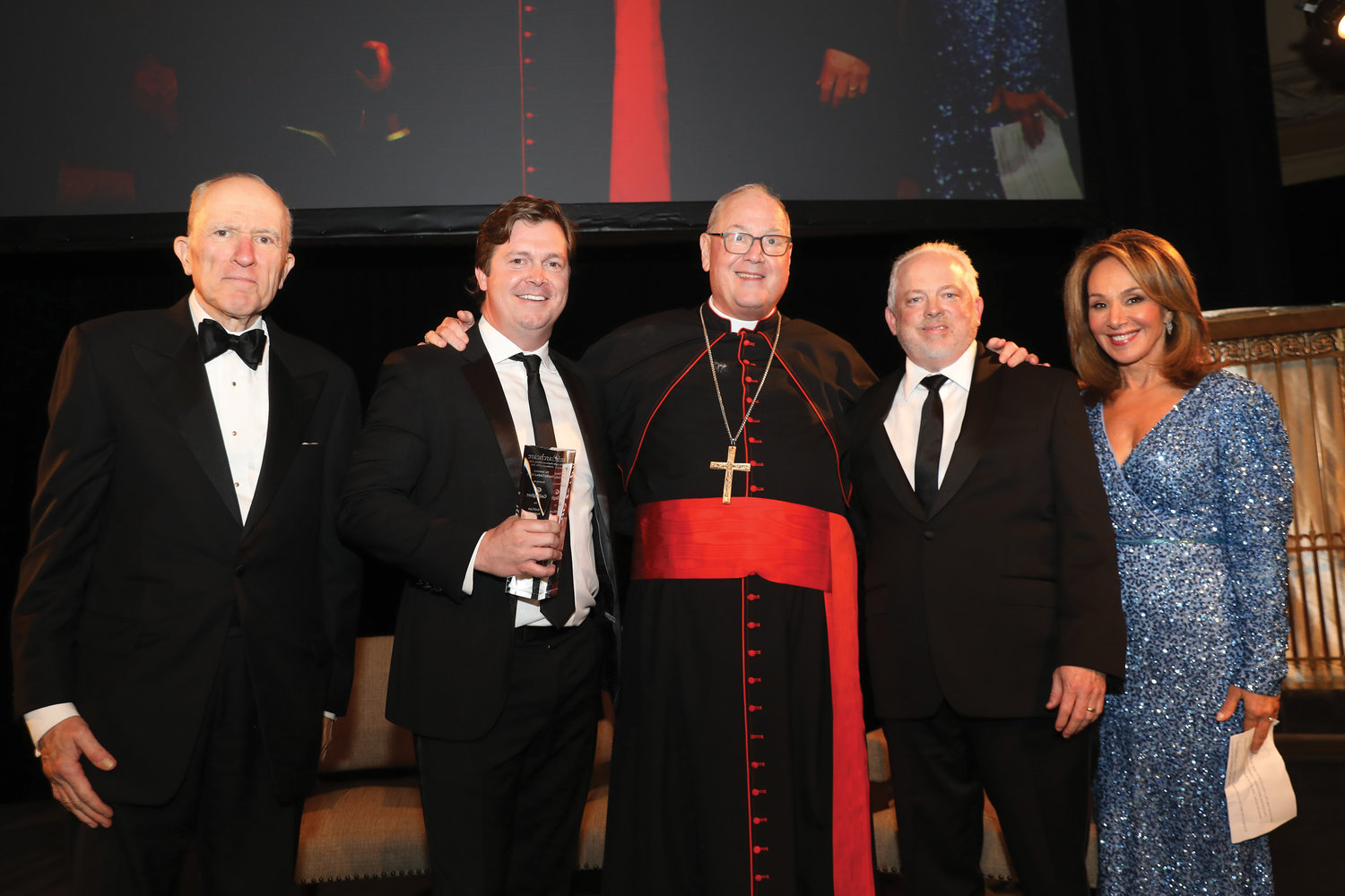 At the ArchCare Gala at Gotham Hall in Manhattan Oct. 27, are, from left: Francis Serbaroli, chairman, ArchCare board of trustees; Brendan Gallagher, president, New York, Gallagher; Cardinal Dolan; Scott LaRue, president and CEO of ArchCare; and Rosanna Scotto, Fox 5 New York. Gallagher and 10-time U.S. Olympic swimming medalist Katie Ledecky, who participated via video, were the honorees. The gala raised a record $1.9 million for ArchCare, the archdiocesan health care system that cares daily for more than 9,000 seniors, the poor and persons with special needs.