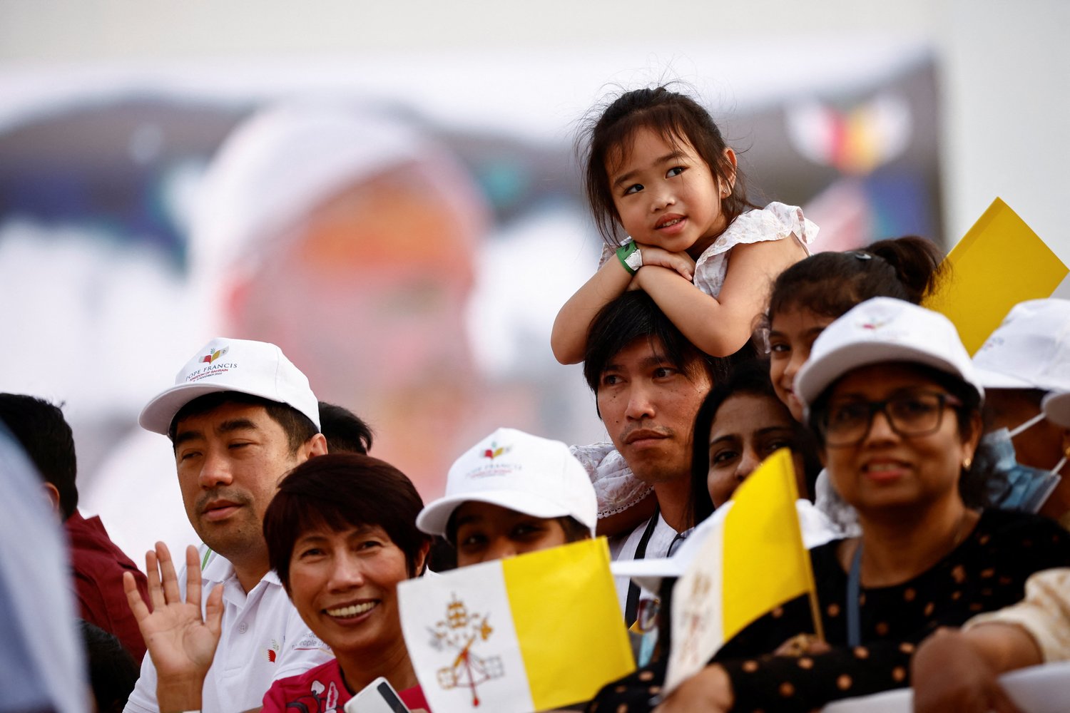 A girl watches as Pope Francis arrives to celebrate Mass at Bahrain National Stadium in Awali, Bahrain, Nov. 5.