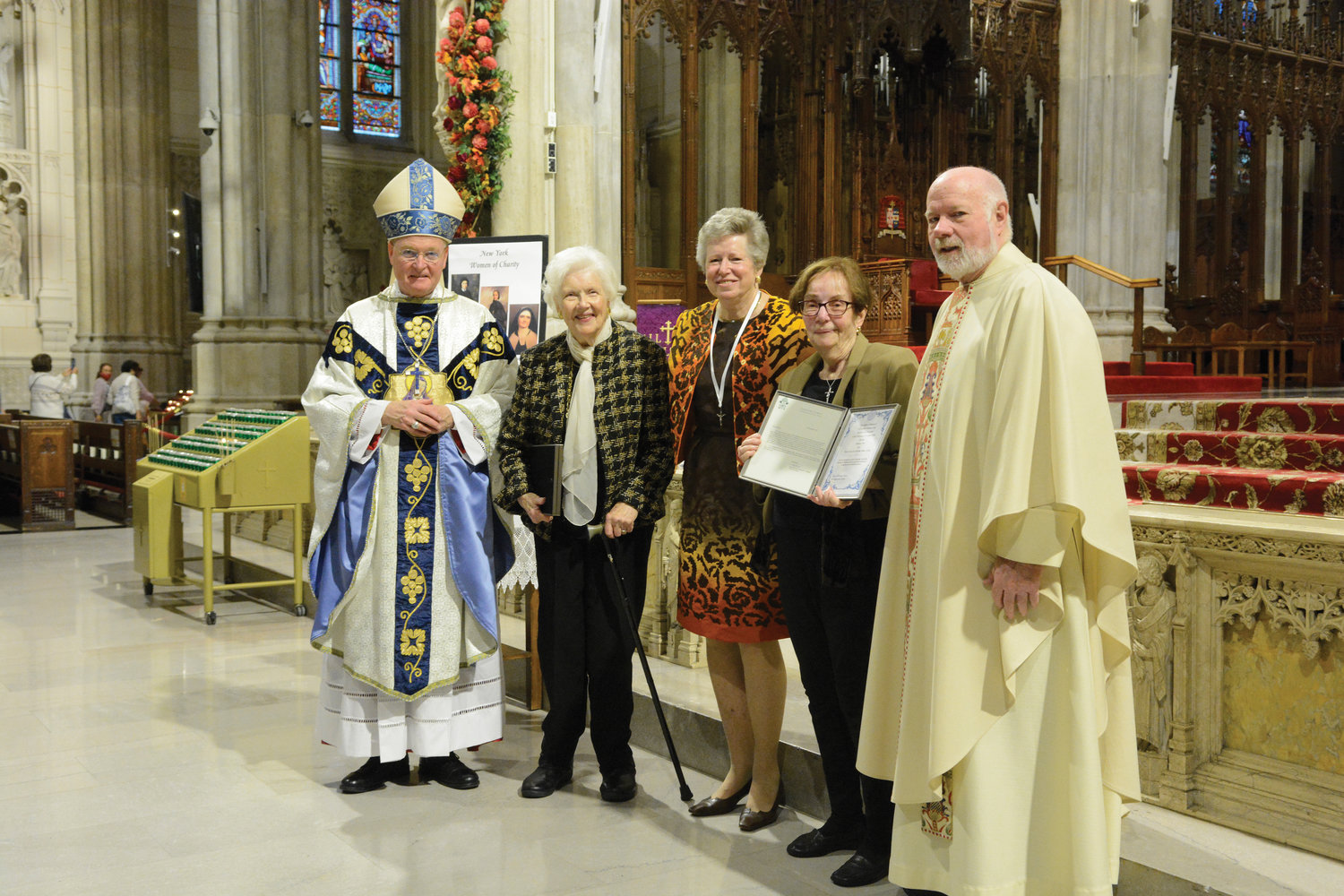 Recipients of the St. Louise de Marillac Award are Anne Martyn, with white scarf to the right of Bishop Whalen and Barbara Neus, with glasses to the left of Msgr. Kevin Sullivan, executive director of archdiocesan Catholic Charities. Mary Buckley Teatum, president of Ladies of Charity, is at center.
